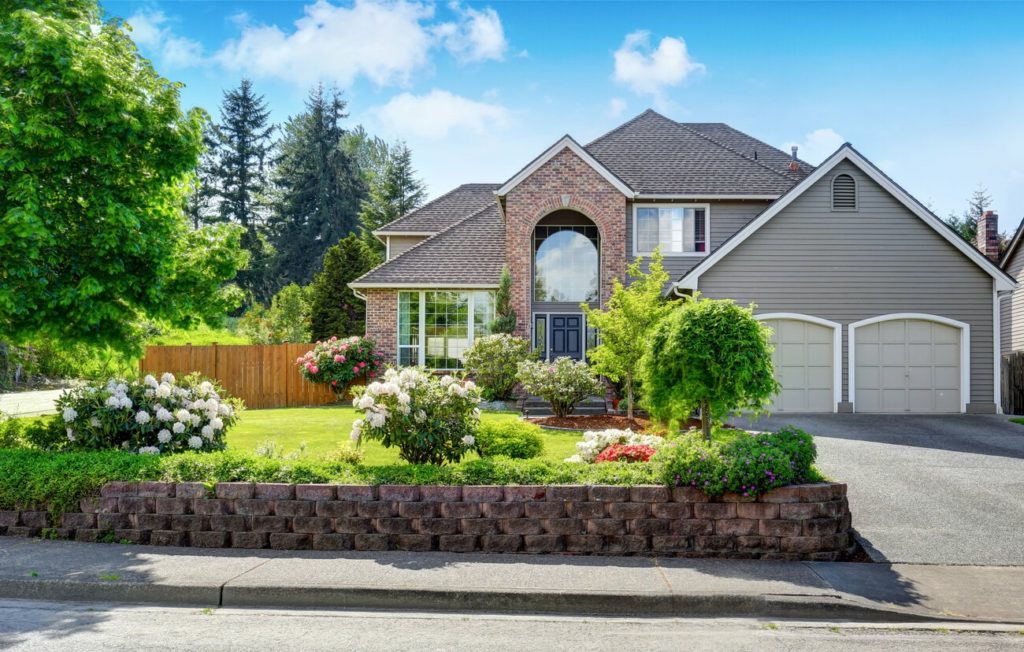 xterior of a residential house with double-storey brick walls and exterior trim on the exterior of a garage.